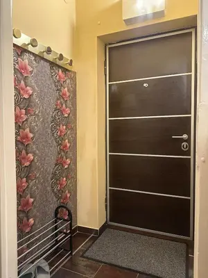 a black door in a room with a flower wall at Suite Top 14 in Belgrade