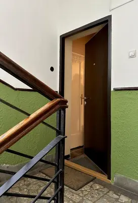a stairway with a green wall and a door at Suite Top 14 in Belgrade