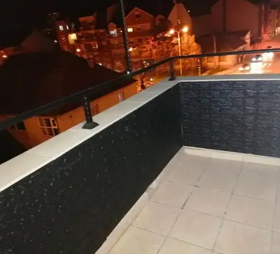 a view of a city at night from a balcony at Centro apartman 3 in Pančevo