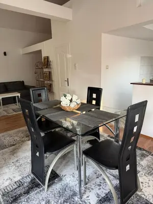 a black dining room table with black chairs and a room at Apartman Tara in Belgrade