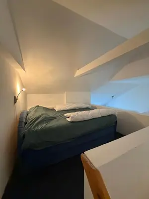 a small bedroom with a bed in a room at Apartman Tara in Belgrade