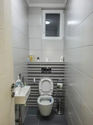 a small bathroom with a toilet and a sink at LOLA home in Beograd