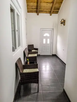 a hallway with chairs and a table and a door at LOLA home in Beograd