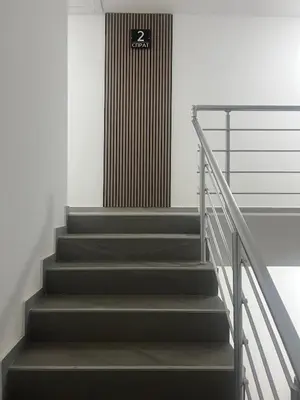 a set of stairs in a building with a sign on it at Harmony Apartment in Surčin