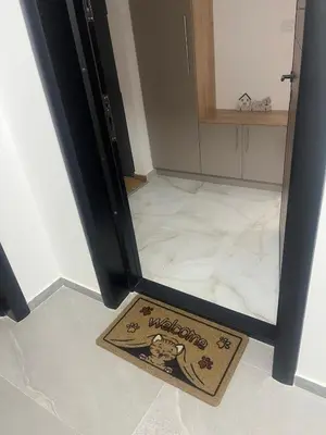 a welcome mat in front of a refrigerator at Harmony Apartment in Surčin