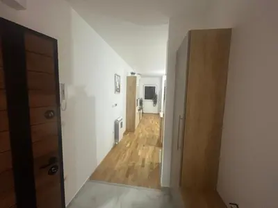an empty room with a hallway with a wooden floor at Harmony Apartment in Surčin