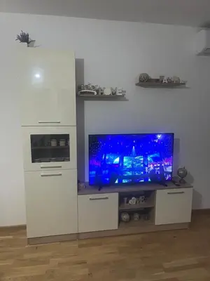 a white entertainment center with a flat screen tv at Harmony Apartment in Surčin