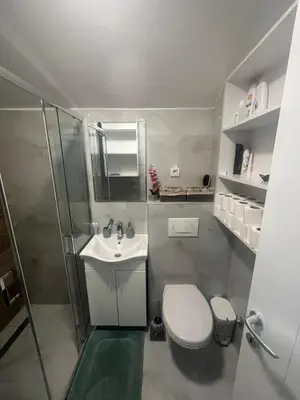 a bathroom with a toilet and a sink and a shower at Harmony Apartment in Surčin