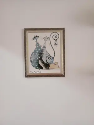 a framed picture of a cat and a dragon at Sweet Dreams Apartment in Arandjelovac
