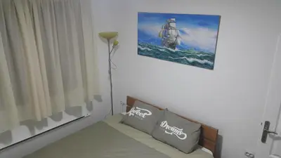 a bedroom with a bed and a picture on the wall at Sweet Dreams Apartment in Arandjelovac