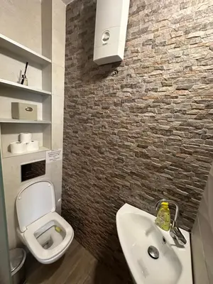 a bathroom with a white toilet and a sink at Urban Escape Zemun in Belgrade