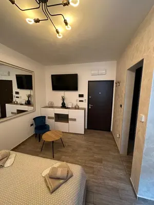 a bedroom with a bed and a desk and a tv at Urban Escape Zemun in Belgrade