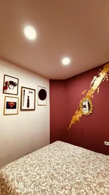 a bedroom with a bed and a red wall at Low cost studio Zeleni Venac in Belgrade