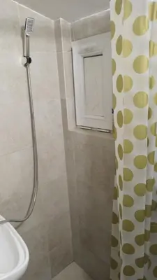 a bathroom with a shower with a shower curtain at Low cost studio Zeleni Venac in Belgrade
