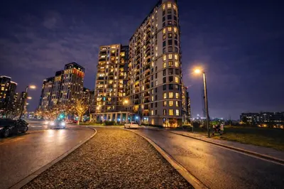 a tall building on a city street at night at Metropoliten Modern Apartment in Belgrade