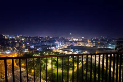 a view of a city at night from a balcony at Metropoliten Modern Apartment in Belgrade