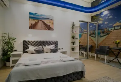 a bedroom with a large bed and a painting on the wall at Moon in Belgrade