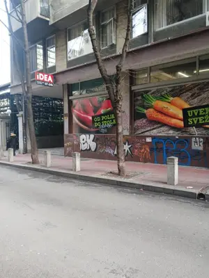a store with graffiti on the side of a building at Moon in Belgrade