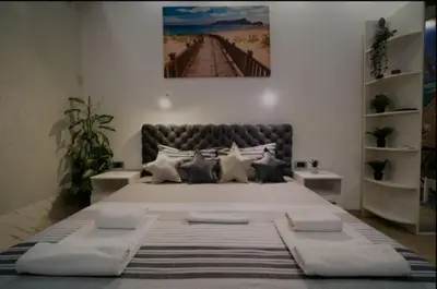 a bedroom with a large bed with a picture on the wall at Moon in Belgrade