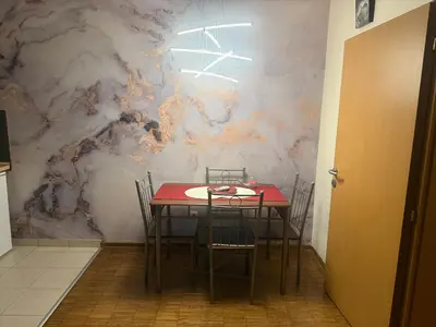 a dining room with a red table and chairs at City Center Apartment Cvijiceva in Belgrade