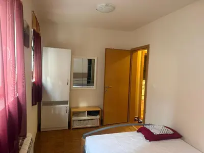 a bedroom with a bed and a door to a room at City Center Apartment Cvijiceva in Belgrade