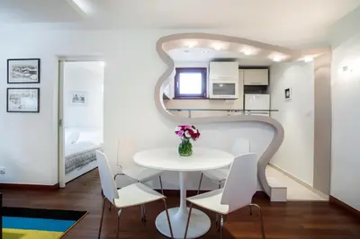 a small dining room with a white table and chairs at Apartment 18 in Belgrade