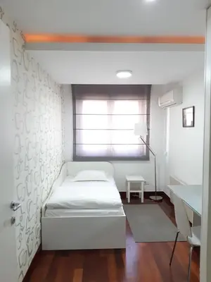a bedroom with a bed and a window and a desk at Apartment 18 in Belgrade