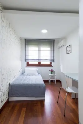 a bedroom with a bed and a desk and a window at Apartment 18 in Belgrade