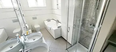 a bathroom with a sink and a toilet and a shower at Apartment 18 in Belgrade