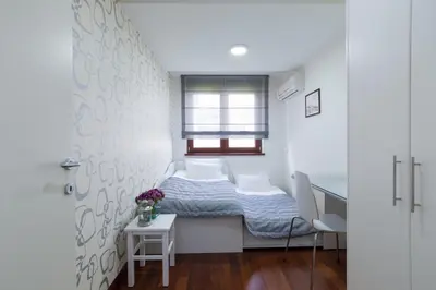 a small bedroom with a bed and a desk at Apartment 18 in Belgrade