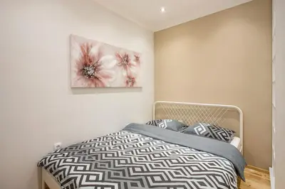 a bedroom with a bed and a painting on the wall at Cozy City Center Nest - Quiet Courtyard Patio in Belgrade