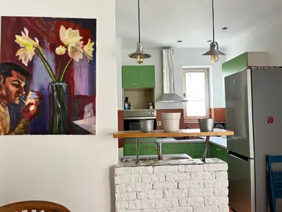 a kitchen with a vase of flowers on the wall at Centrala Apartment in Belgrade