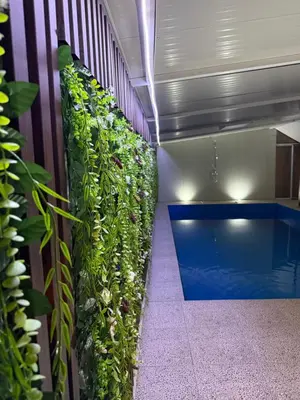 a vertical garden on a wall next to a swimming pool at Barrique apartmani sa zatvorenim bazenom in Smederevo