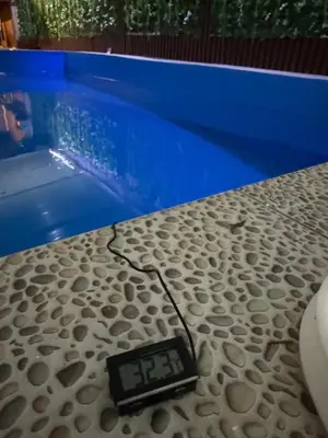 a scale sitting on a table next to a pool at Barrique apartmani sa zatvorenim bazenom in Smederevo