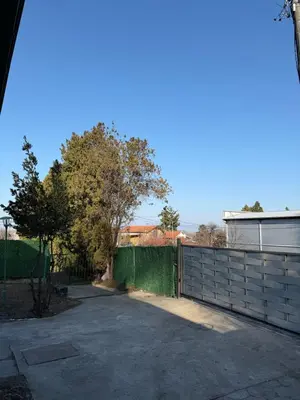 a driveway with a fence and trees in the background at Barrique apartmani sa zatvorenim bazenom in Smederevo