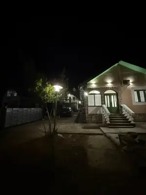 a house with a street light in the dark at Barrique apartmani sa zatvorenim bazenom in Smederevo