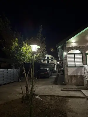 a street light in front of a house at night at Barrique apartmani sa zatvorenim bazenom in Smederevo