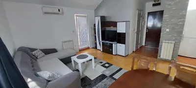 a living room with a couch and a table at Michigan Hill Apartmant in Belgrade