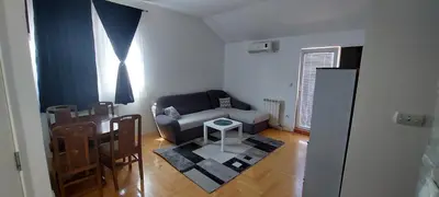 a living room with a couch and a table at Michigan Hill Apartmant in Belgrade