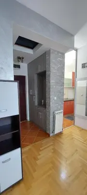 an empty room with a kitchen and a fireplace at Michigan Hill Apartmant in Belgrade