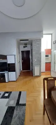 an empty living room with a fireplace and a kitchen at Michigan Hill Apartmant in Belgrade