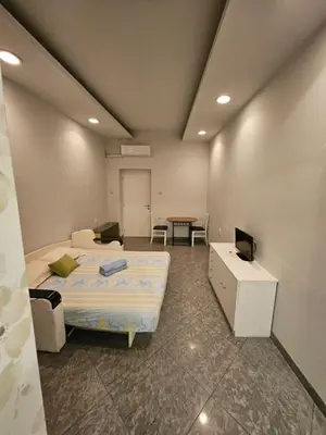 a room with a bed and a table in it at Prime Location Studio in Belgrade