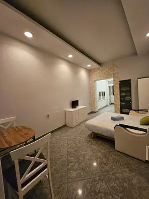 a bedroom with a bed and a table and a couch at Prime Location Studio in Belgrade