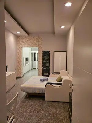 a bedroom with a large bed and a bathroom at Prime Location Studio in Belgrade