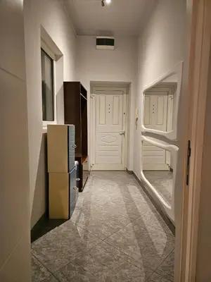 a hallway with a white door and a refrigerator at Prime Location Studio in Belgrade