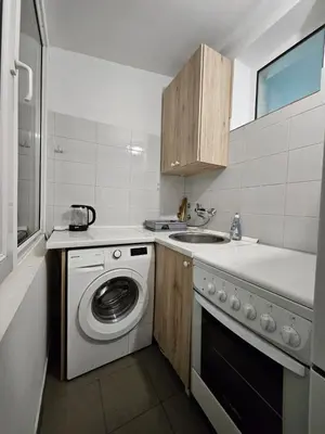 a kitchen with a washing machine and a sink at Prime Location Studio in Belgrade