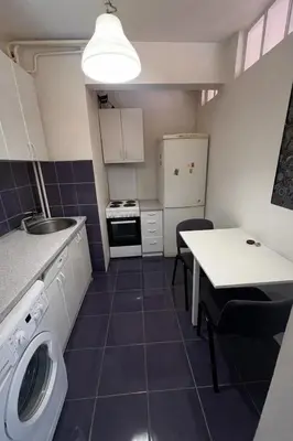 a kitchen with a washer and a table at Summer Edition Belgrade in Belgrade