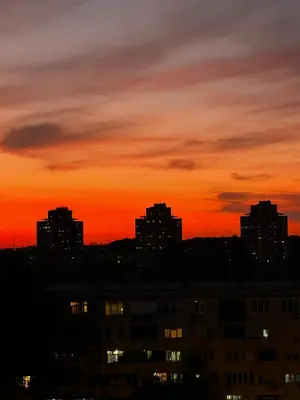 a city skyline with a sunset in the background at Summer Edition Belgrade in Belgrade