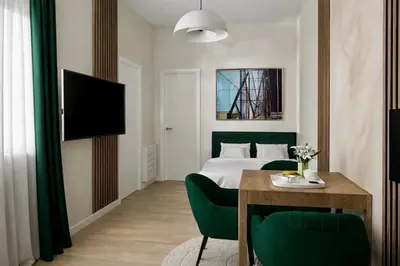 a hotel room with a bed and a table and chairs at Apartman Dixy 3 in Belgrade