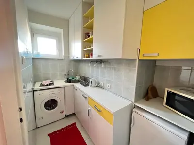 a kitchen with a washing machine and a washer at Bright modern downtown studio in Belgrade